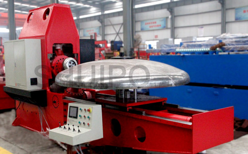 Dished head spinning machine